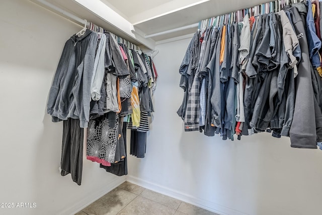 spacious closet with tile patterned floors