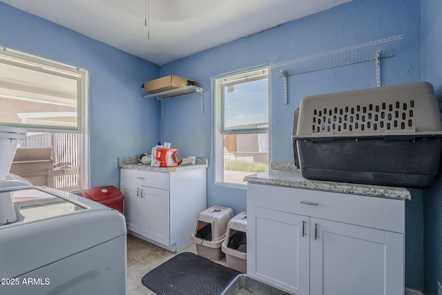 washroom featuring laundry area and light tile patterned floors