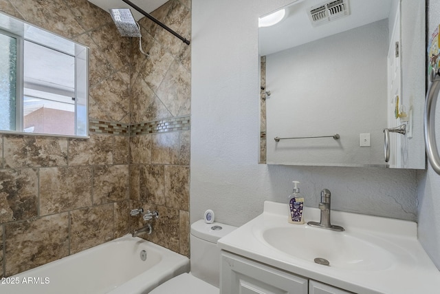 full bath with visible vents, vanity, a textured wall, toilet, and shower / bathing tub combination