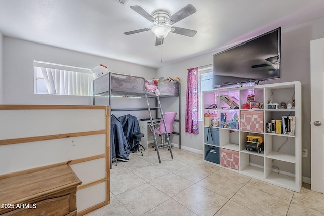 bedroom featuring baseboards, a ceiling fan, and tile patterned floors