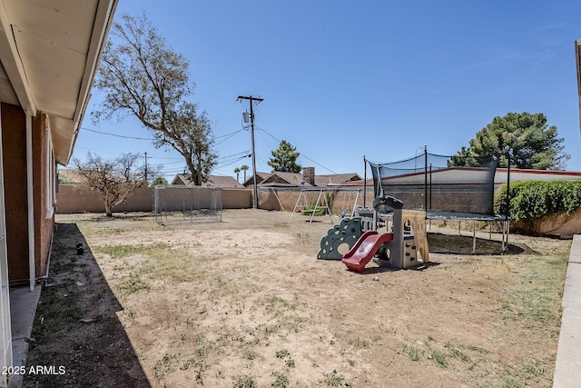 view of yard with a fenced backyard and a trampoline