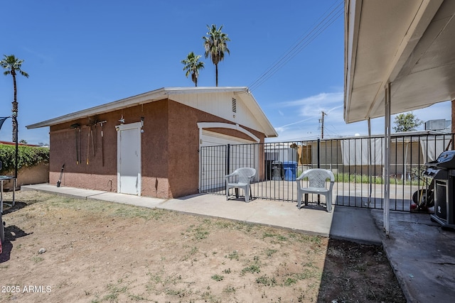 exterior space with fence, grilling area, and a detached garage