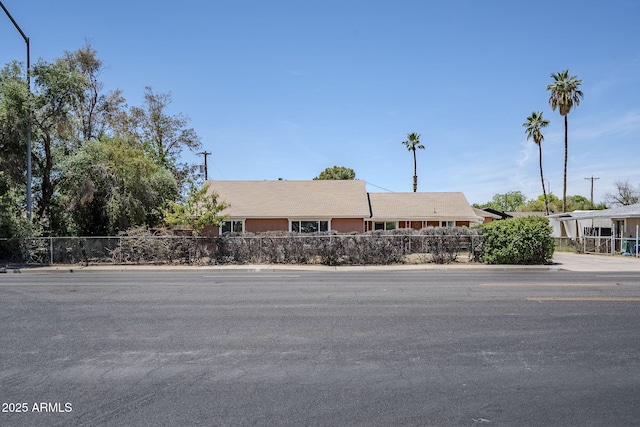 ranch-style house featuring fence