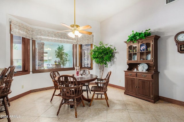 tiled dining room featuring ceiling fan