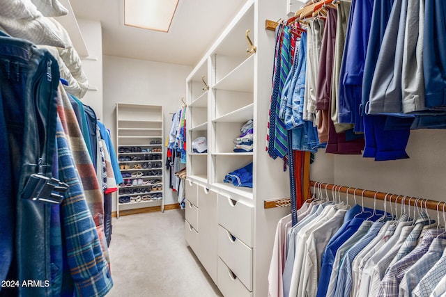 walk in closet featuring light carpet