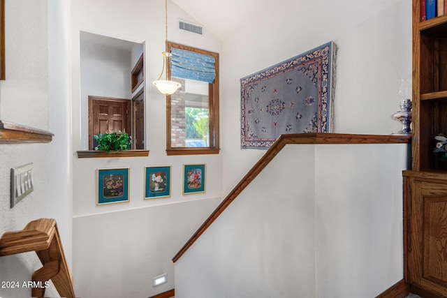 stairway with vaulted ceiling