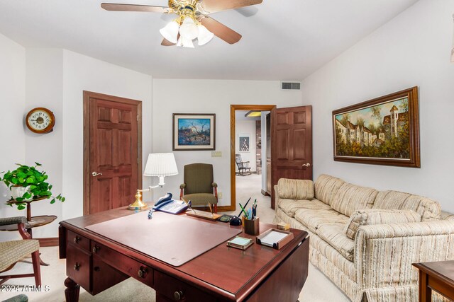 carpeted office with ceiling fan