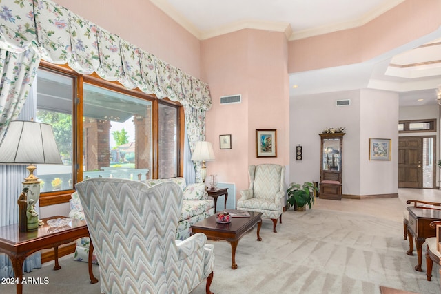 living room with a high ceiling, light carpet, and crown molding