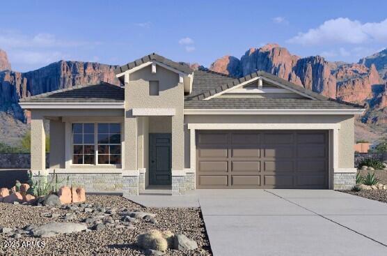 10524 W Bloch Rd, Tolleson, AZ 85353 - view of front of property featuring a garage, concrete driveway, a mountain view, and stone siding