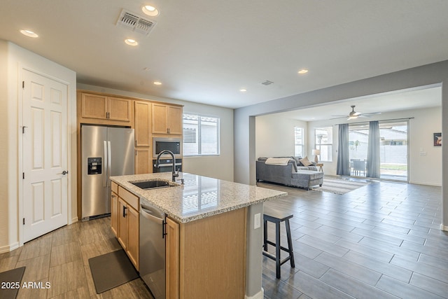 17618 W Medlock Dr, Litchfield Park, AZ 85340 - kitchen with appliances with stainless steel finishes, a sink, plenty of natural light, light stone countertops, and recessed lighting