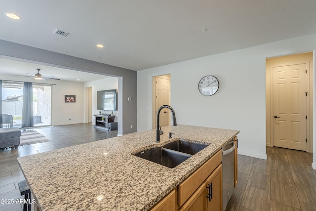 17618 W Medlock Dr, Litchfield Park, AZ 85340 - kitchen with a sink, ceiling fan, stainless steel dishwasher, open floor plan, and light stone counters