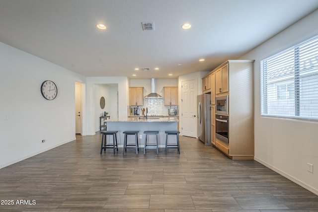 17618 W Medlock Dr, Litchfield Park, AZ 85340 - kitchen featuring wall chimney exhaust hood, stainless steel appliances, a sink, a kitchen island with sink, and recessed lighting