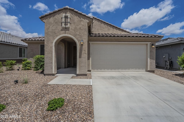 17618 W Medlock Dr, Litchfield Park, AZ 85340 - mediterranean / spanish house featuring a tile roof, stucco siding, concrete driveway, and an attached garage