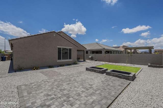 17618 W Medlock Dr, Litchfield Park, AZ 85340 - rear view of house featuring a fenced backyard, a patio area, and stucco siding
