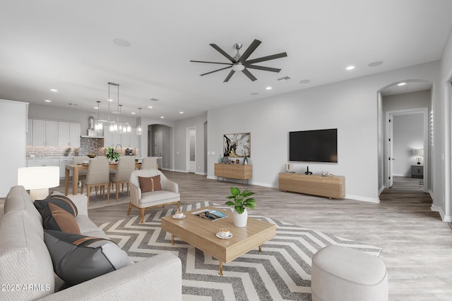 living room featuring ceiling fan and light hardwood / wood-style flooring