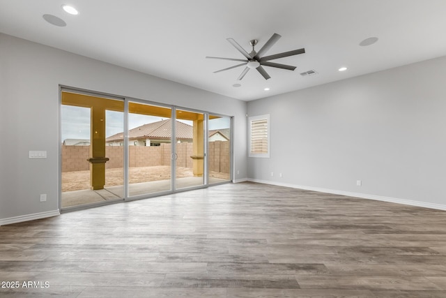 empty room featuring light hardwood / wood-style floors and ceiling fan