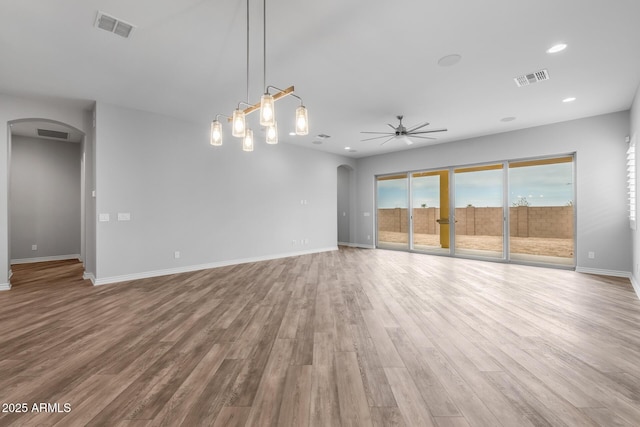 unfurnished living room featuring ceiling fan and light wood-type flooring