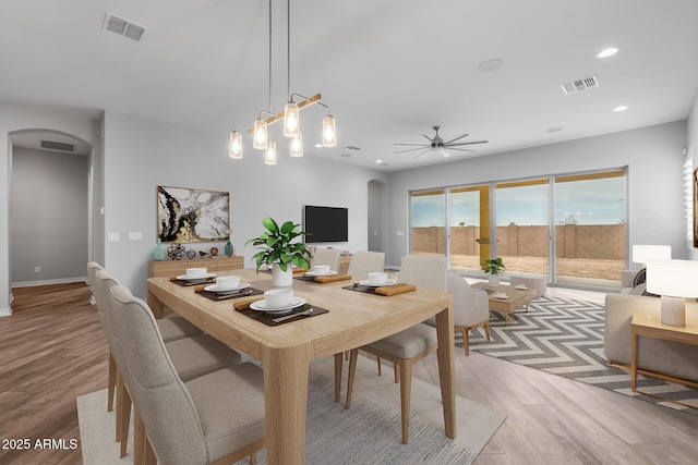 dining room with ceiling fan and light hardwood / wood-style floors