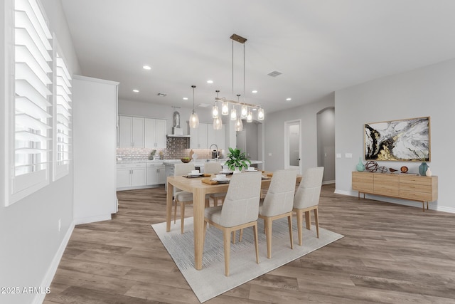 dining room with sink and light hardwood / wood-style flooring