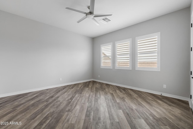 unfurnished room featuring ceiling fan and dark hardwood / wood-style floors