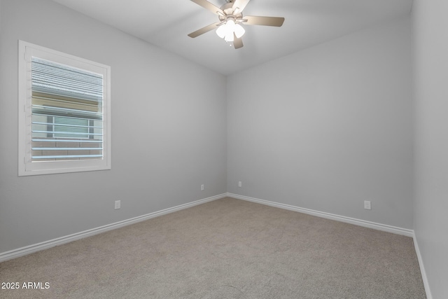 spare room featuring ceiling fan and light colored carpet