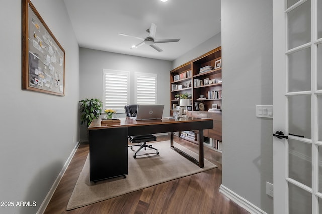 home office with ceiling fan and dark hardwood / wood-style floors