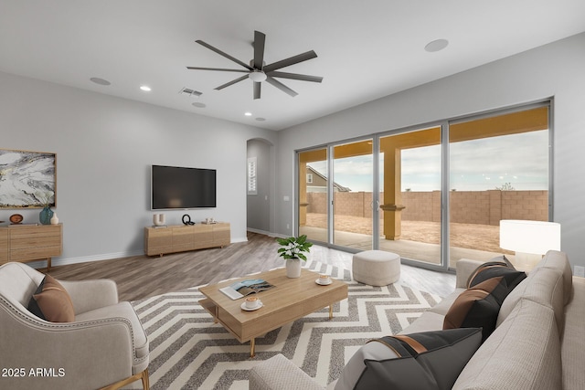 living room featuring ceiling fan and light wood-type flooring