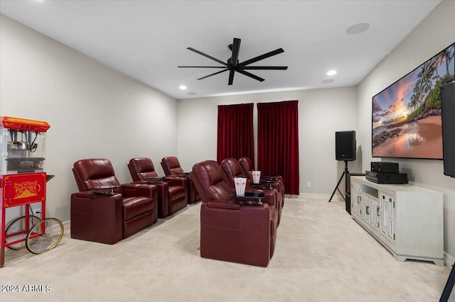 cinema room featuring ceiling fan and light colored carpet