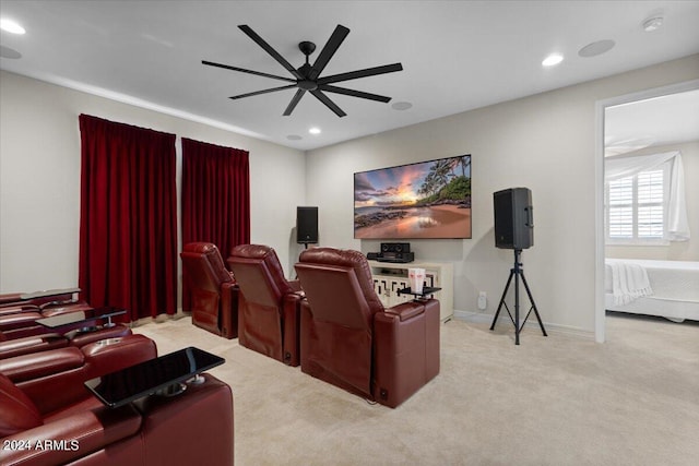 home theater featuring ceiling fan and light colored carpet