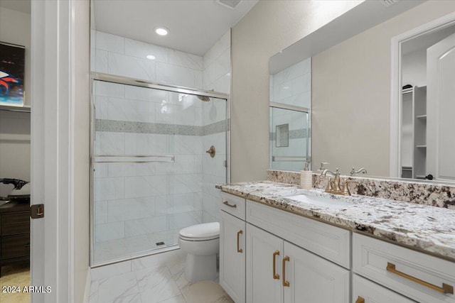 bathroom with vanity, toilet, and an enclosed shower