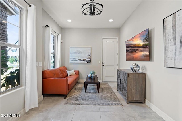 living area featuring a notable chandelier and light tile patterned floors