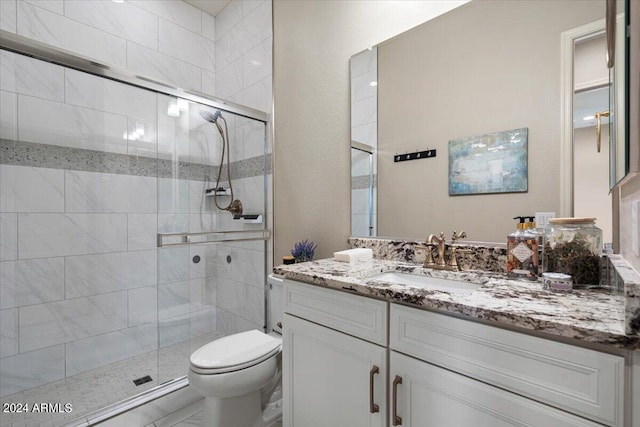 bathroom with vanity, toilet, and walk in shower