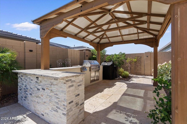 view of patio with a gazebo, an outdoor kitchen, and area for grilling