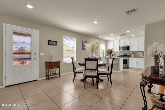 dining space featuring light tile flooring