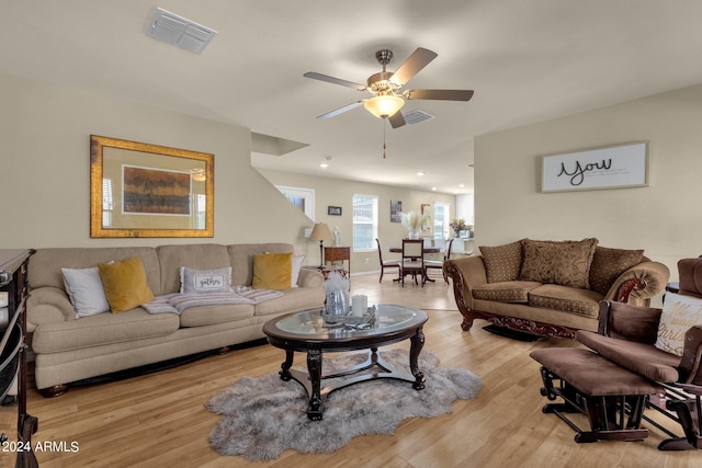 living room featuring ceiling fan and light hardwood / wood-style flooring