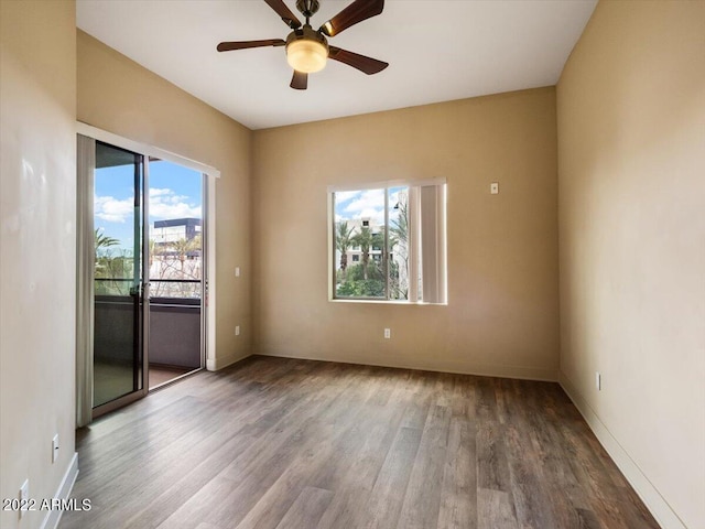 empty room with plenty of natural light, ceiling fan, and hardwood / wood-style flooring