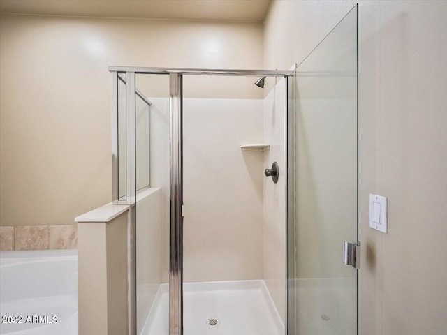 bathroom with shower with separate bathtub