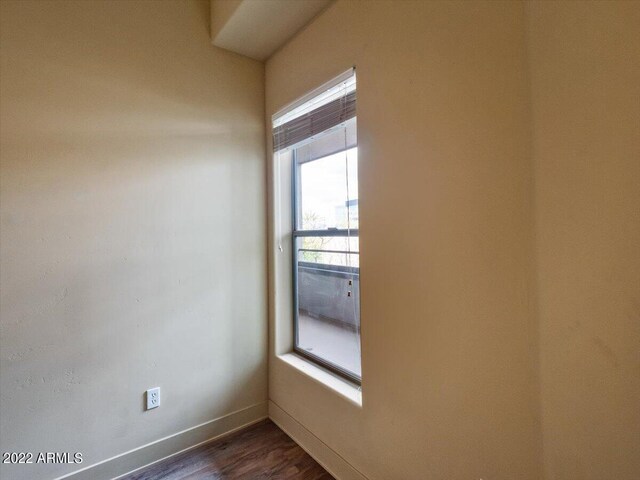 unfurnished room featuring dark hardwood / wood-style floors