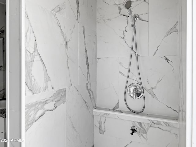 interior details featuring a tile shower