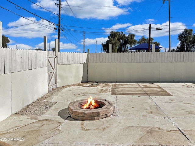 view of patio with a fire pit