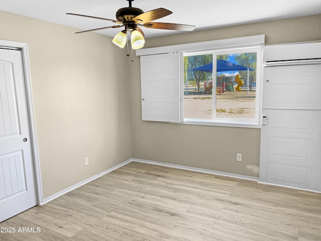 unfurnished bedroom with ceiling fan, light hardwood / wood-style floors, and an AC wall unit