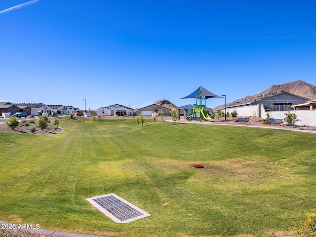 view of yard with a residential view, playground community, and visible vents