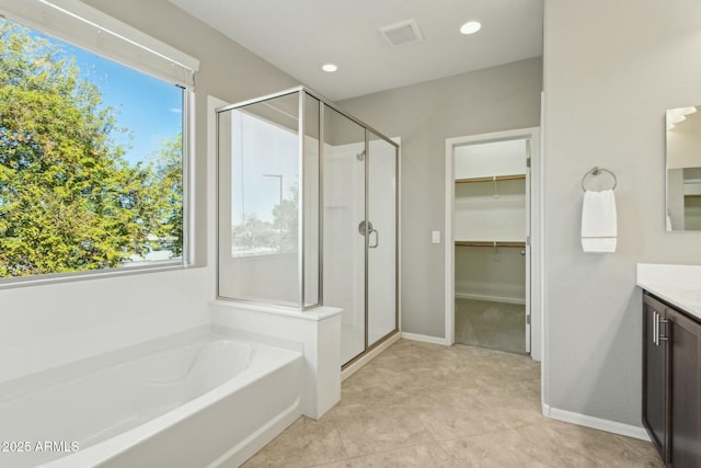 bathroom featuring tile patterned floors, vanity, and separate shower and tub