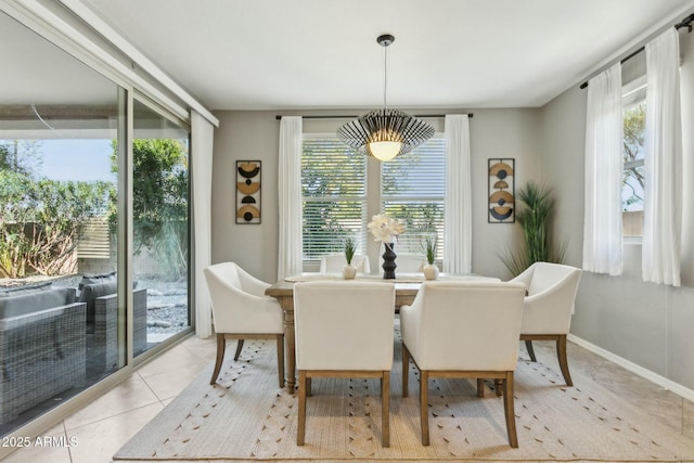 dining space with a wealth of natural light and light tile patterned flooring