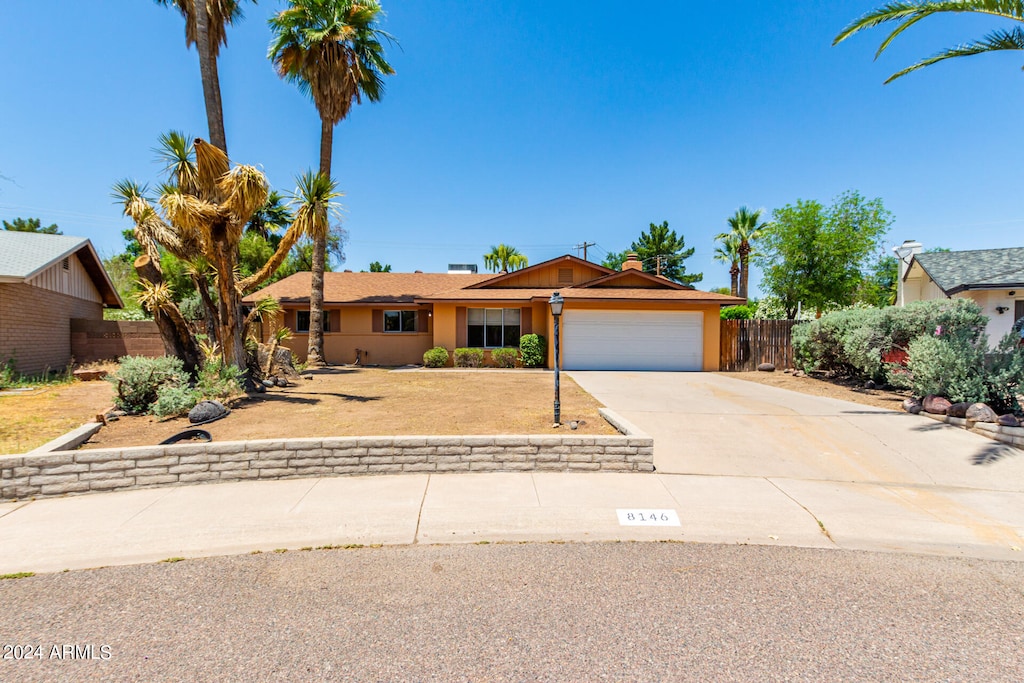 ranch-style home featuring a garage