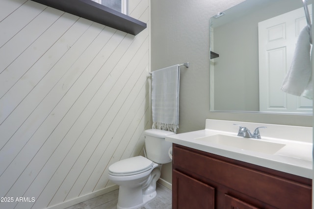 bathroom featuring tile patterned floors, vanity, and toilet