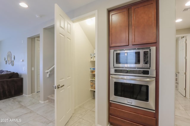 kitchen with light tile patterned floors and appliances with stainless steel finishes