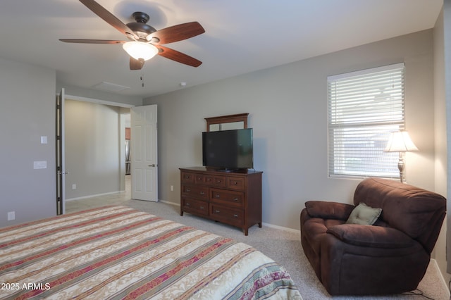 carpeted bedroom featuring stainless steel refrigerator and ceiling fan