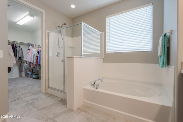 bathroom with separate shower and tub