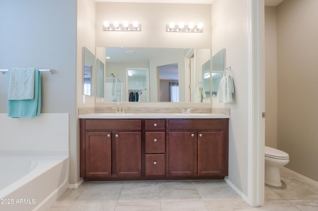 bathroom featuring tile patterned flooring, vanity, toilet, and a tub